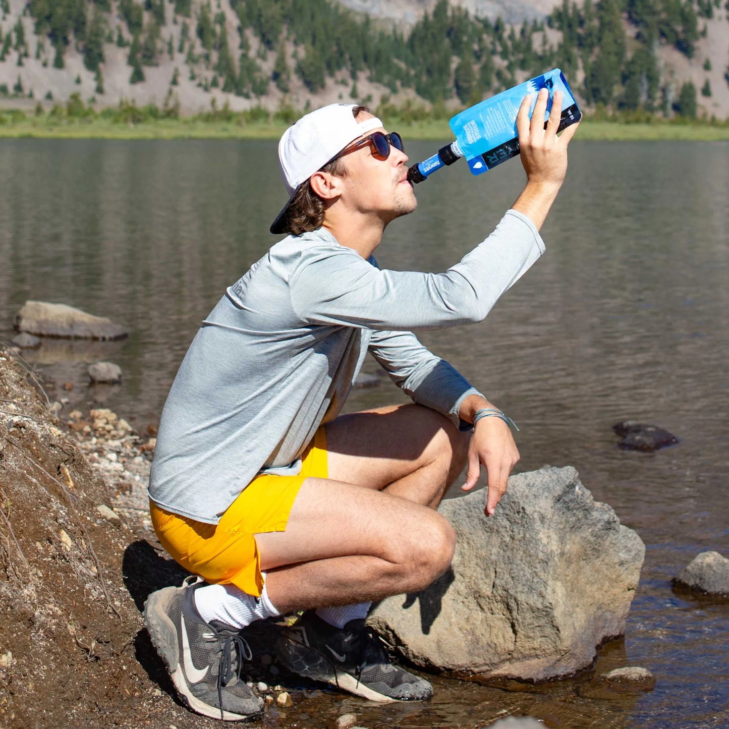 "Sawyer SP128 MINI Water Filter - ultralight 0.1 micron survival water purifier in blue for emergencies and camping."