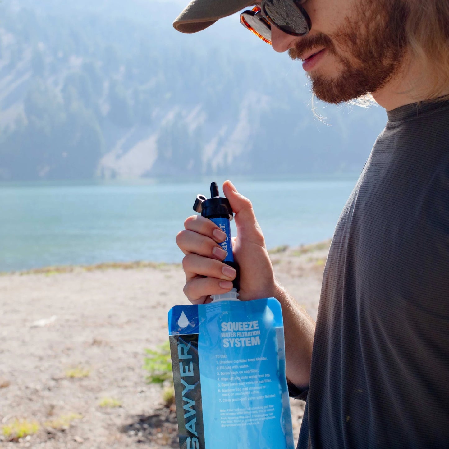 "Sawyer SP128 MINI Water Filter - ultralight 0.1 micron survival water purifier in blue for emergencies and camping."