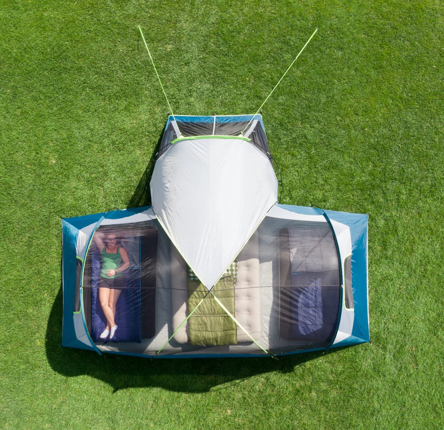 "10-Person Modified Dome Tent with Screen Porch set up in a forest campsite, showcasing its spacious design and inviting screen porch."