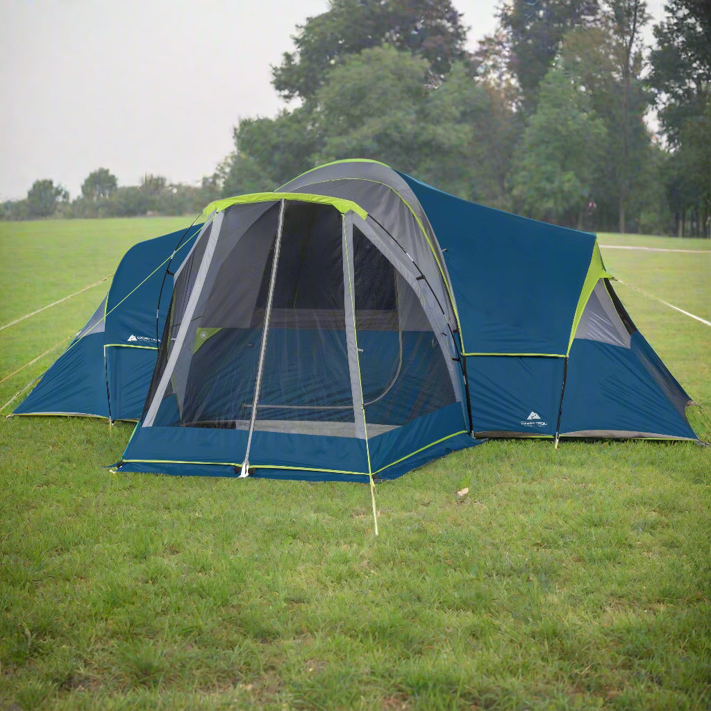"10-Person Modified Dome Tent with Screen Porch set up in a forest campsite, showcasing its spacious design and inviting screen porch."