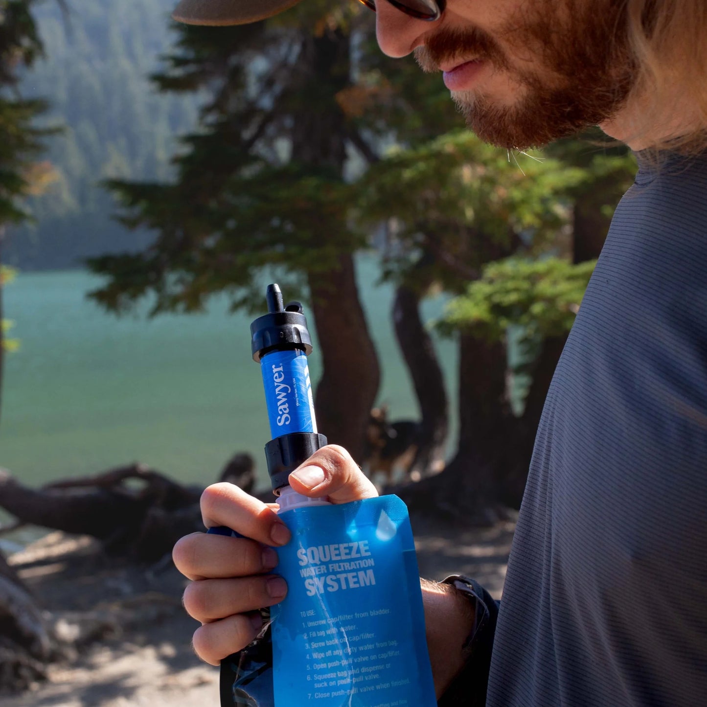 "Sawyer SP128 MINI Water Filter - ultralight 0.1 micron survival water purifier in blue for emergencies and camping."