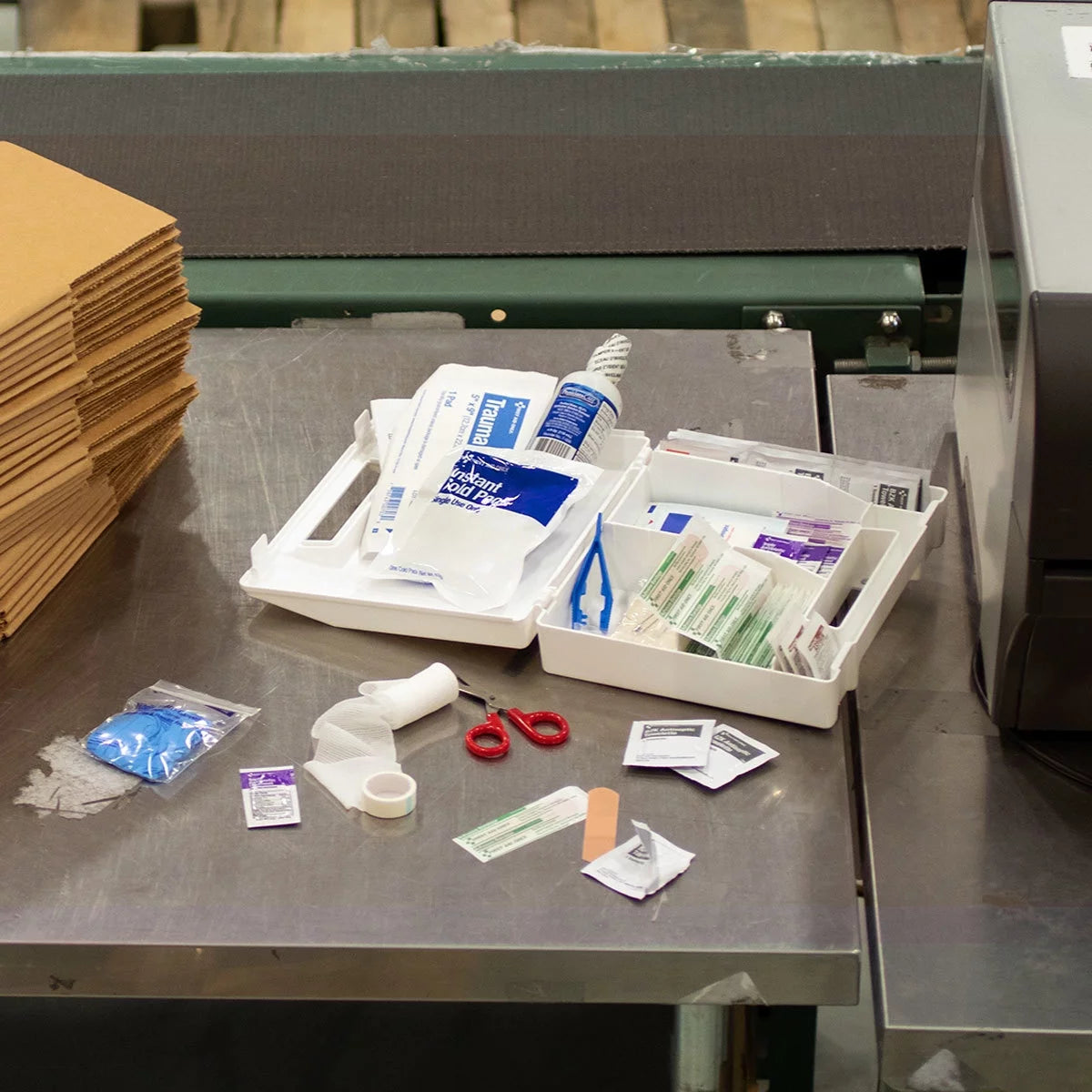 "ANSI-Compliant 107-Piece First Aid Kit displayed with medical supplies, showcasing its compact and organized design."