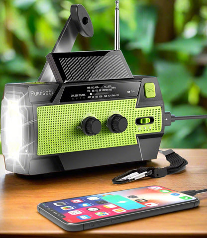 Image of the Puiuisoul 4000mAh weather radio, featuring a hand crank, solar charging panel, LED flashlight, and motion sensor reading lamp, displayed on a clean white background.
